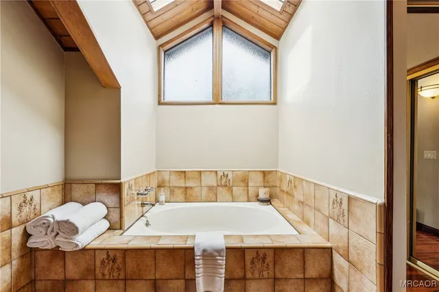 a en suite bathroom with a granite countertop sink and a mirror