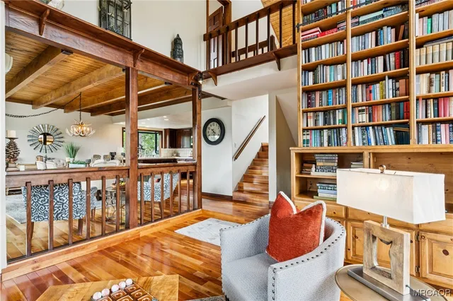 a dining room with furniture and a floor to ceiling window