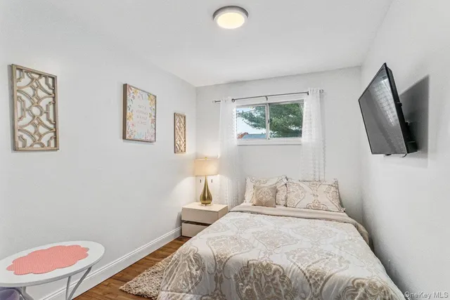 a bedroom with a bed and a flat screen tv