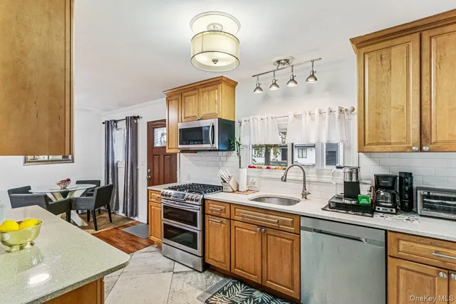 a kitchen with a sink stove and microwave