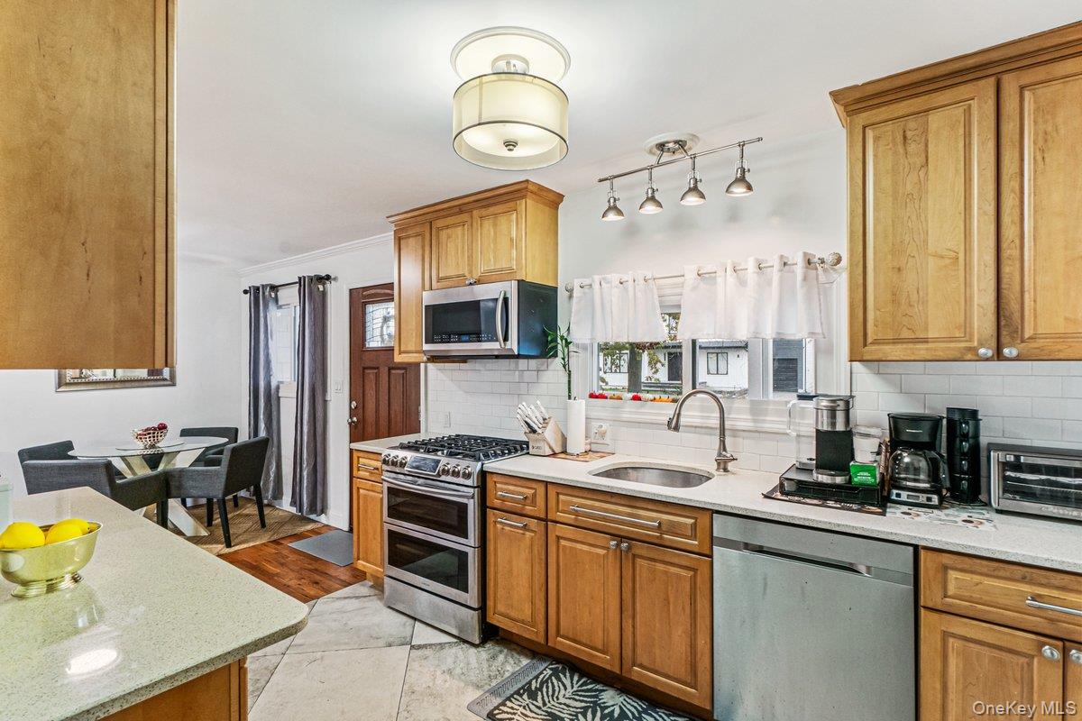 5 Terry Lane Plainview, NY 11803 - Photo 6 of 29 a kitchen with a sink stove and microwave