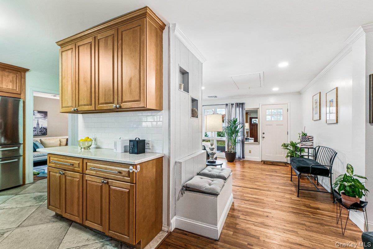 5 Terry Lane Plainview, NY 11803 - Photo 8 of 29 a open kitchen with stainless steel appliances granite countertop a refrigerator a sink dishwasher a dining table and chairs with wooden floor