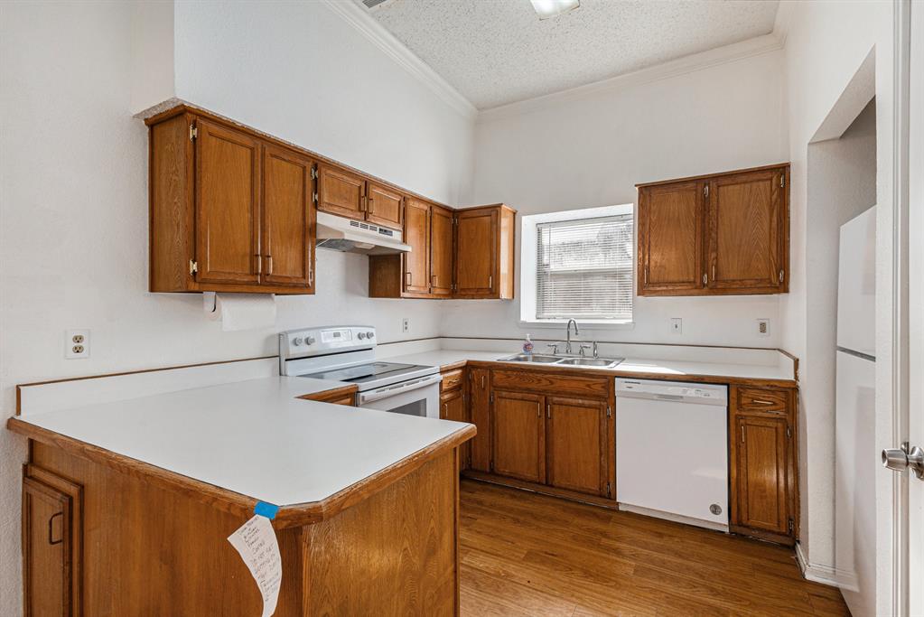 1105 Irene Drive Mesquite, TX 75149 - Photo 14 of 23 a kitchen with stainless steel appliances a stove a sink cabinets and a refrigerator