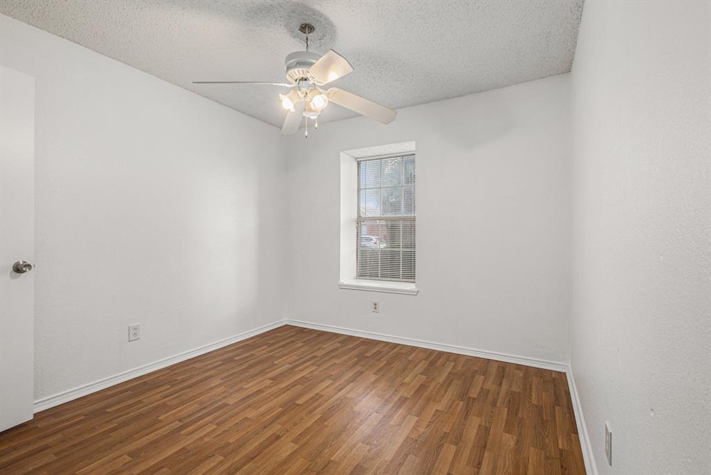 1105 Irene Drive Mesquite, TX 75149 - Photo 18 of 23 an empty room with wooden floor and windows