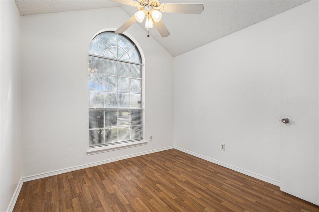 1105 Irene Drive Mesquite, TX 75149 - Photo 19 of 23 an empty room with wooden floor fan and windows