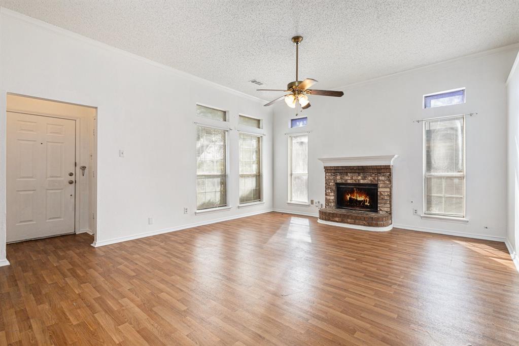 1105 Irene Drive Mesquite, TX 75149 - Photo 9 of 23 an empty room with wooden floor fireplace and windows