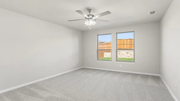 an empty room with a window and a ceiling fan