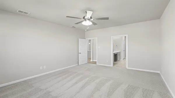 a view of an empty room with a ceiling fan