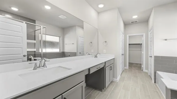 a bathroom with a double vanity sink and a mirror