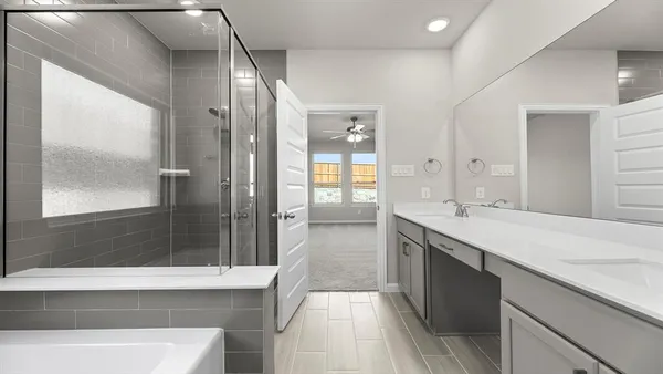 a large bathroom with a large tub shower and sink