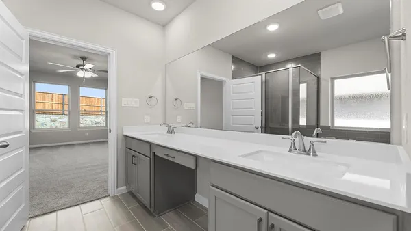 a bathroom with a sink double vanity and a mirror