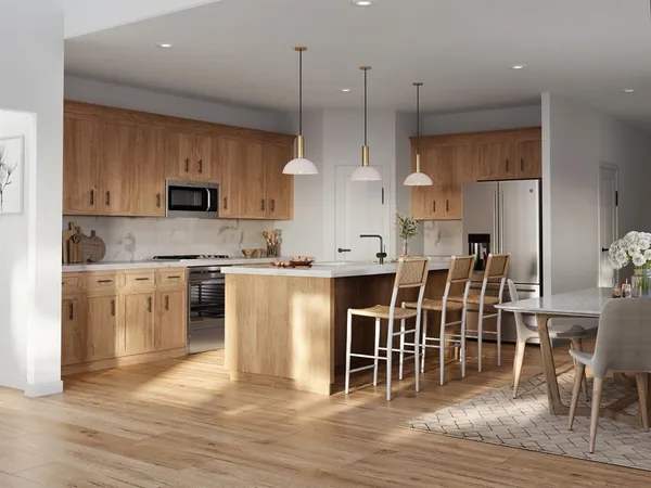 a view of kitchen with stainless steel appliances refrigerator stove microwave and cabinets