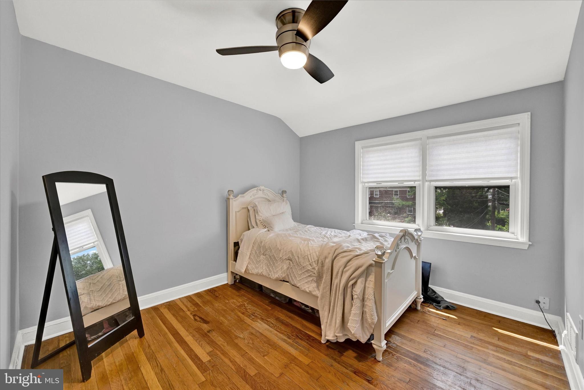1203 Walker Avenue Baltimore, MD 21239 - Photo 11 of 31 a bedroom with a bed and wooden floor