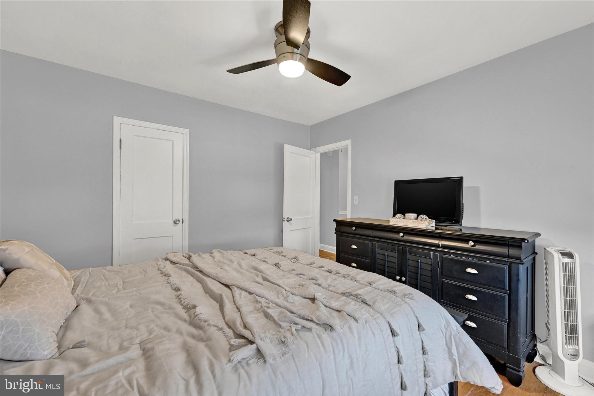 1203 Walker Avenue Baltimore, MD 21239 - Photo 13 of 31 a bedroom with a bed and a flat screen tv