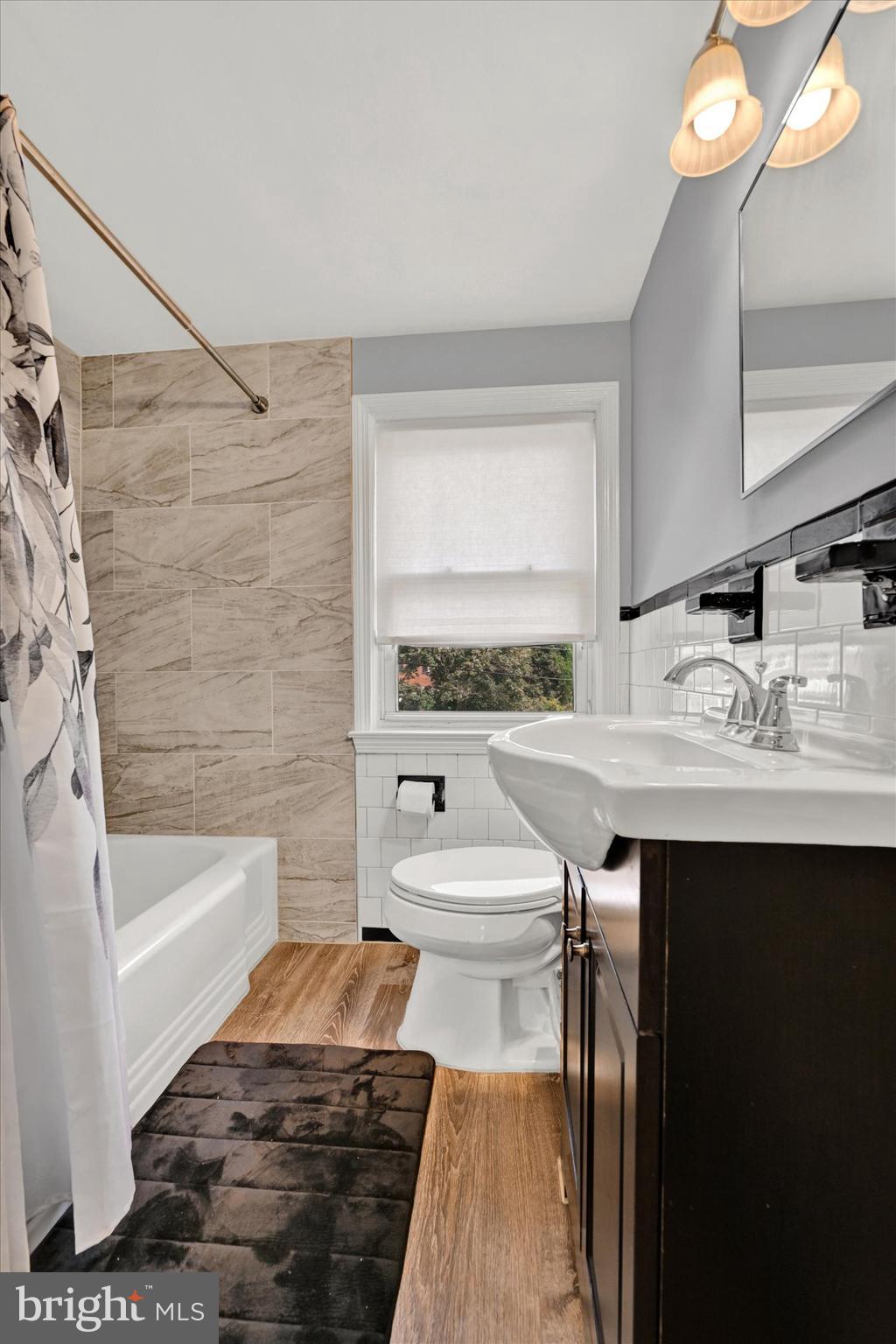 1203 Walker Avenue Baltimore, MD 21239 - Photo 15 of 31 a bathroom with a sink a toilet and bathtub