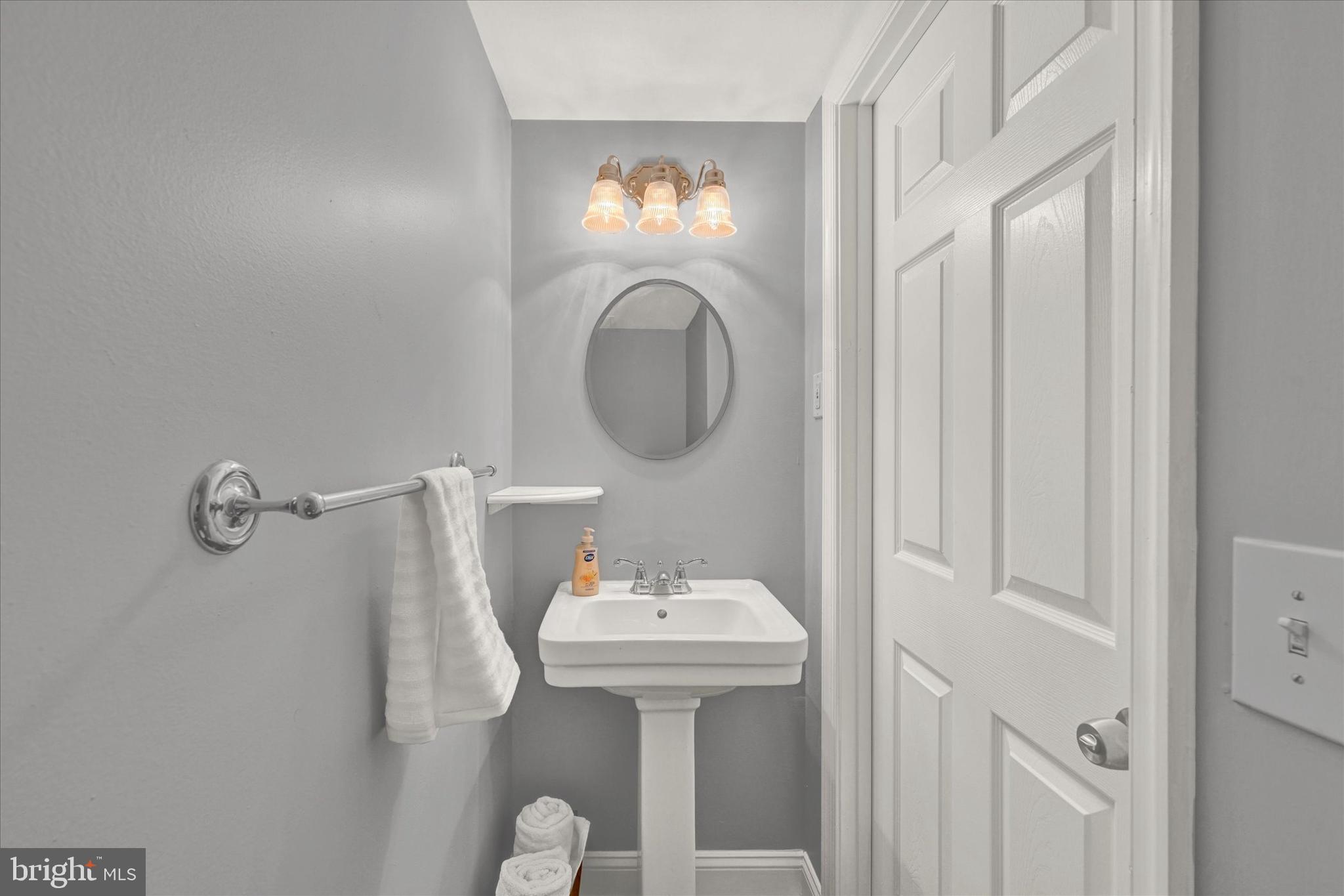 1203 Walker Avenue Baltimore, MD 21239 - Photo 16 of 31 a bathroom with a sink and a mirror