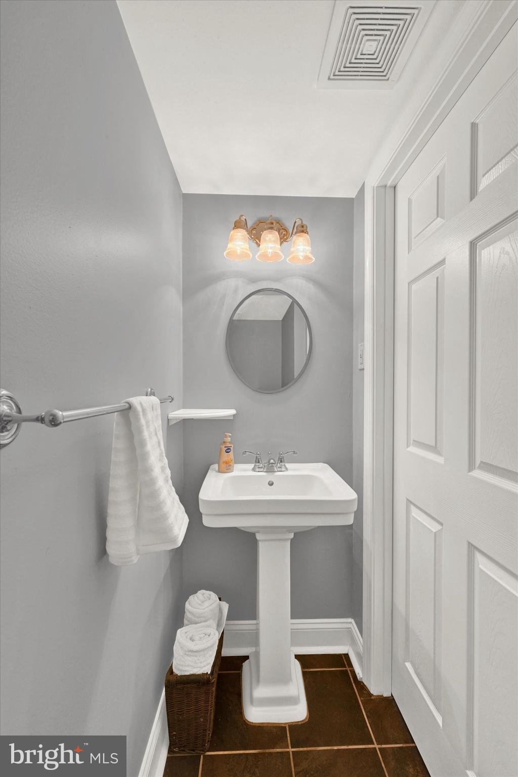 1203 Walker Avenue Baltimore, MD 21239 - Photo 17 of 31 a bathroom with a sink and a mirror