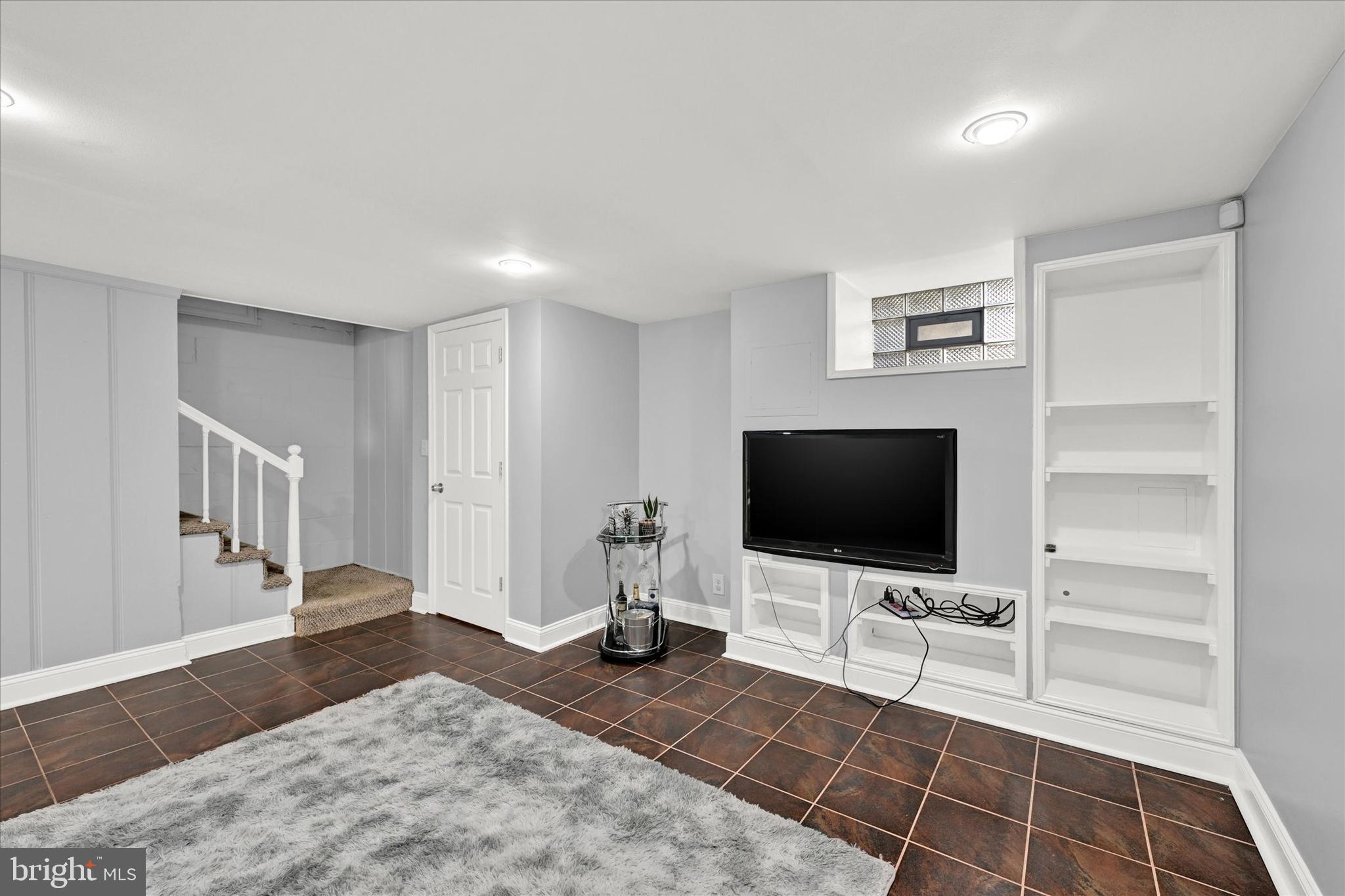 1203 Walker Avenue Baltimore, MD 21239 - Photo 18 of 31 a living room with furniture and a flat screen tv