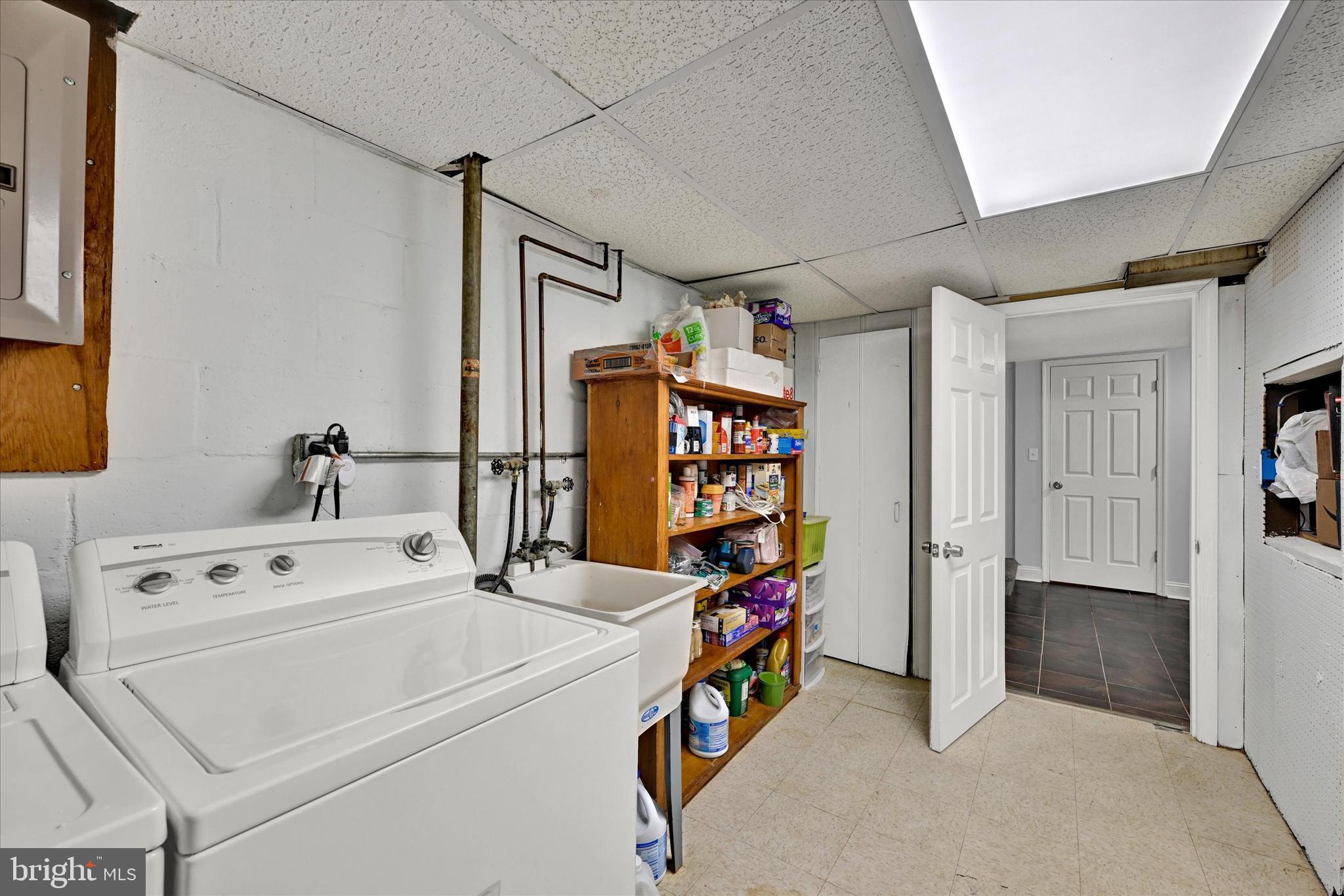 1203 Walker Avenue Baltimore, MD 21239 - Photo 21 of 31 a storage room with washer and dryer