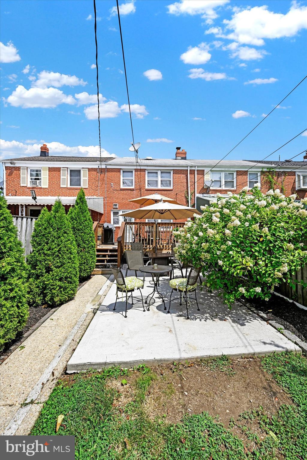 1203 Walker Avenue Baltimore, MD 21239 - Photo 26 of 31 a view of a patio with a table and chairs under an umbrella