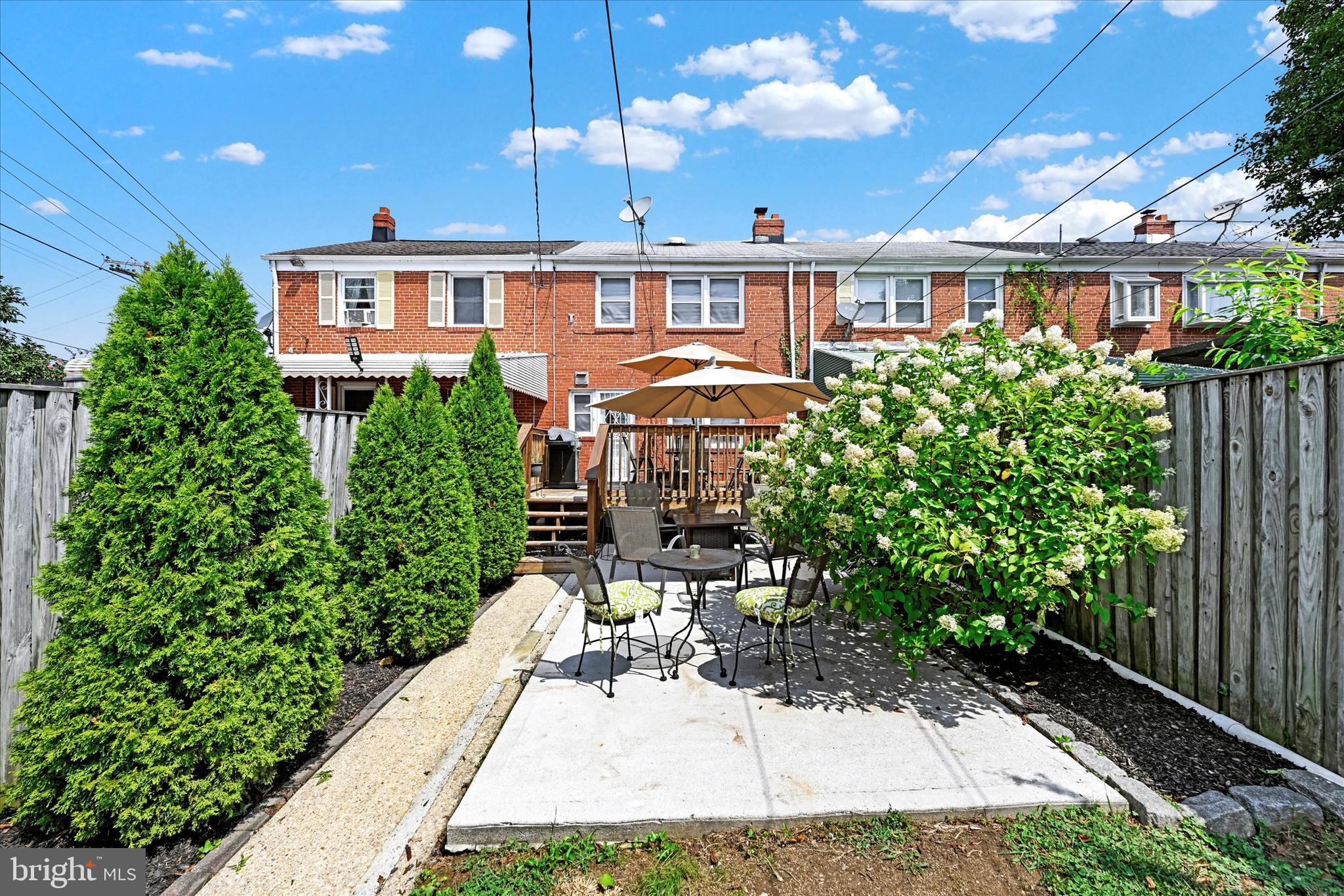 1203 Walker Avenue Baltimore, MD 21239 - Photo 27 of 31 a view of a patio with table and chairs and potted plants