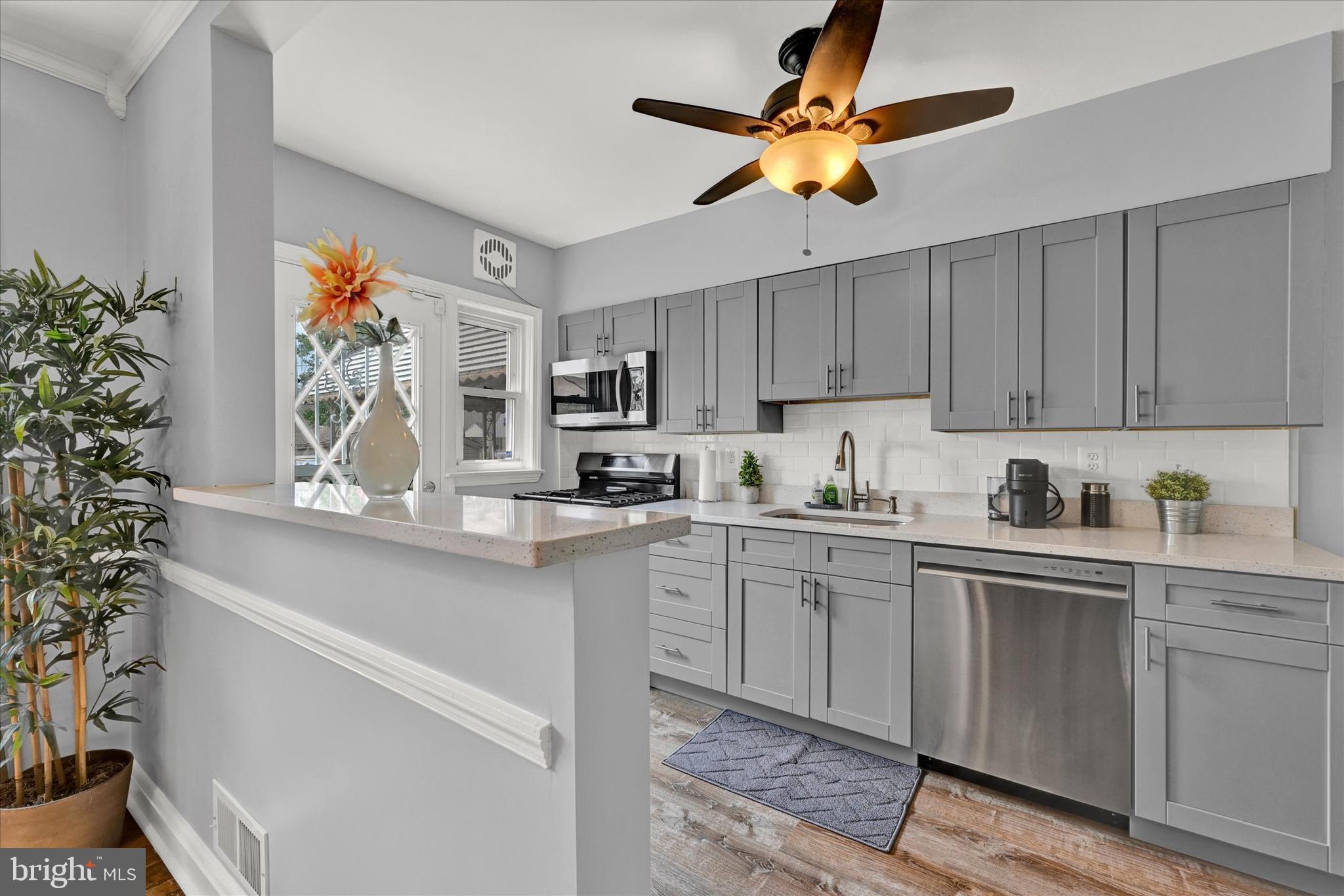 1203 Walker Avenue Baltimore, MD 21239 - Photo 7 of 31 a kitchen with stainless steel appliances granite countertop a sink a stove and cabinets