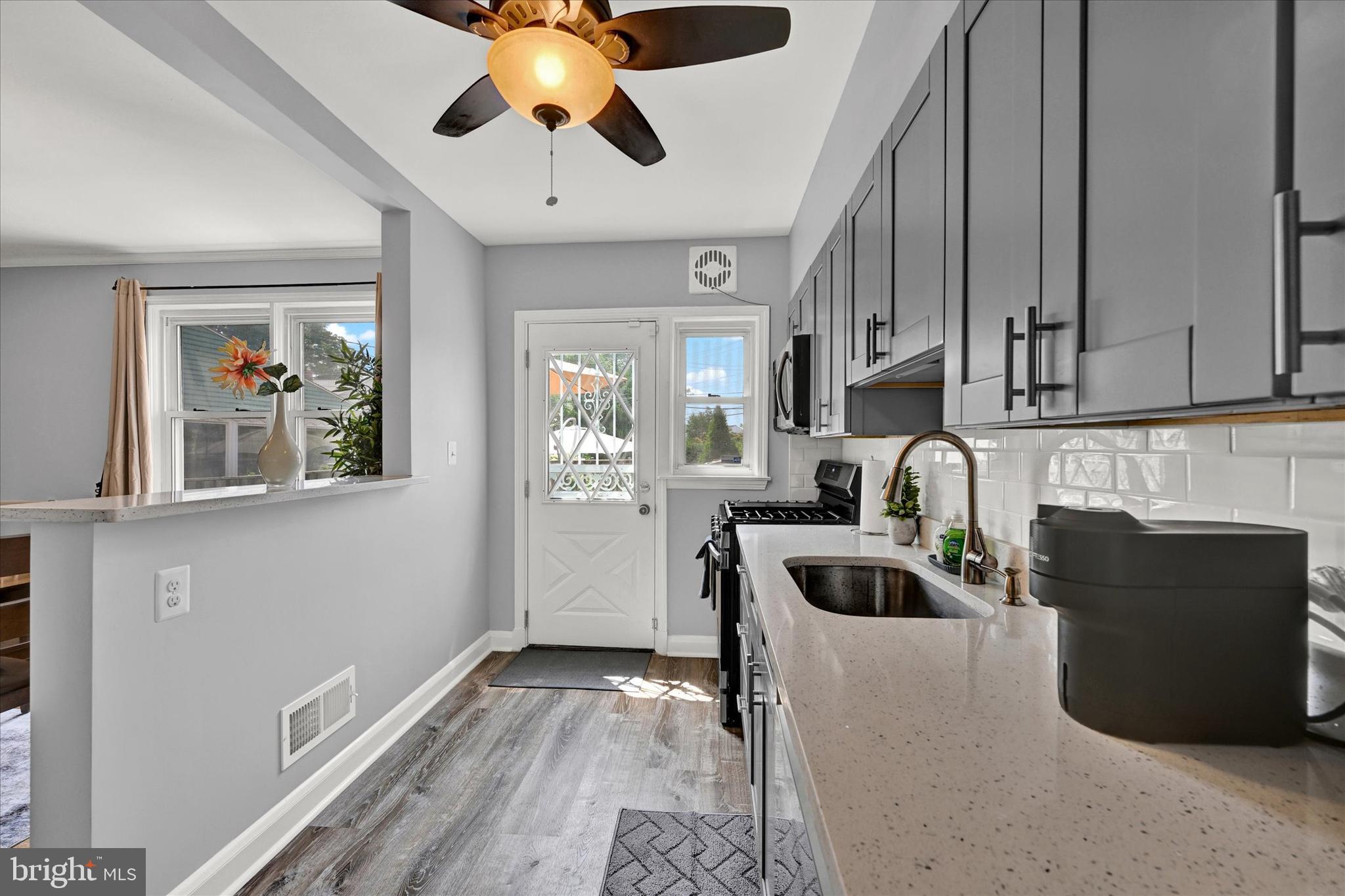 1203 Walker Avenue Baltimore, MD 21239 - Photo 8 of 31 a kitchen with granite countertop a stove and a refrigerator