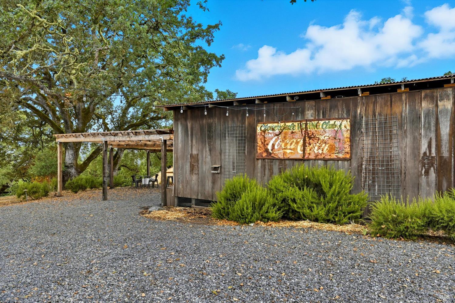 31000 Pine Mountain Road Cloverdale, CA 95425 - Photo 54 of 61 Charming rustic barn setting with pergola seating area, ideal for outdoor gatherings and casual entertaining.