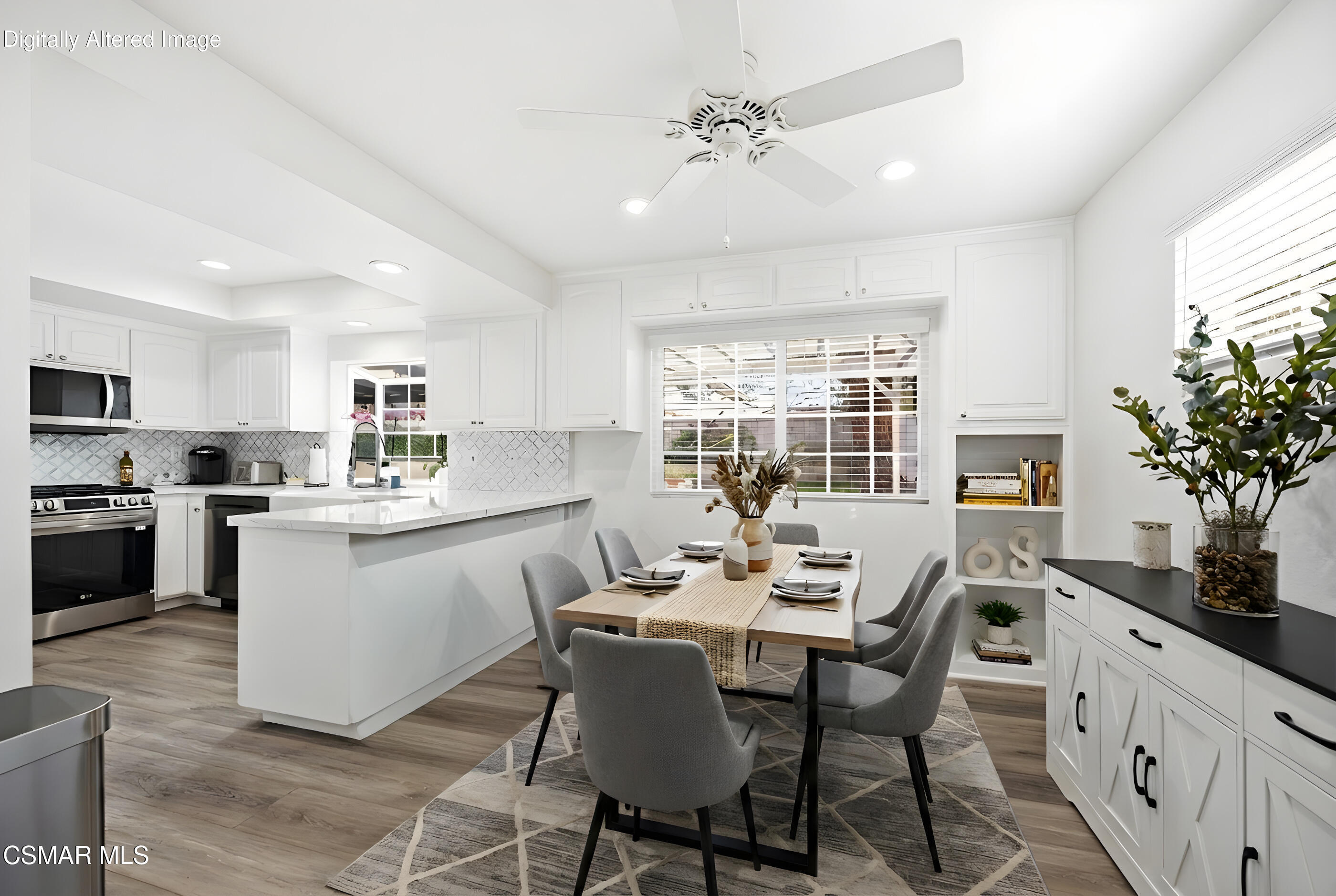 3598 Scofield Avenue Simi Valley, CA 93063 - Photo 15 of 86 a kitchen with a table chairs refrigerator and microwave