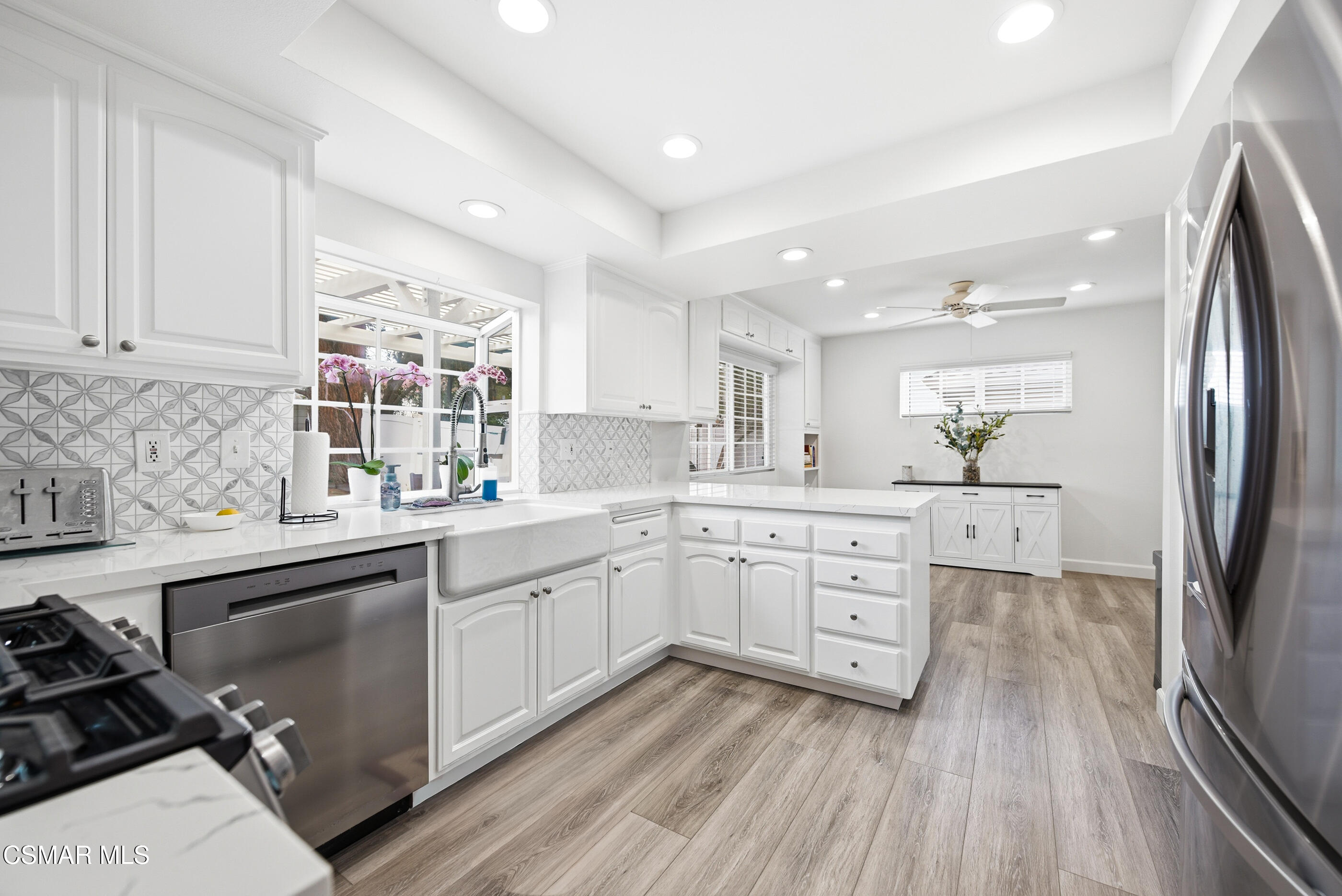 3598 Scofield Avenue Simi Valley, CA 93063 - Photo 19 of 86 a kitchen with a sink wooden floor and stainless steel appliances