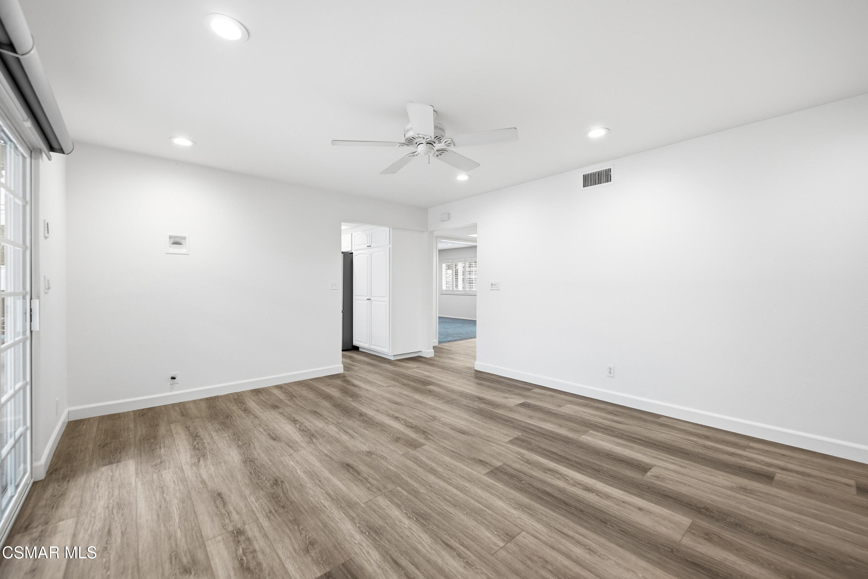 3598 Scofield Avenue Simi Valley, CA 93063 - Photo 30 of 86 an empty room with wooden floor ceiling fan and windows
