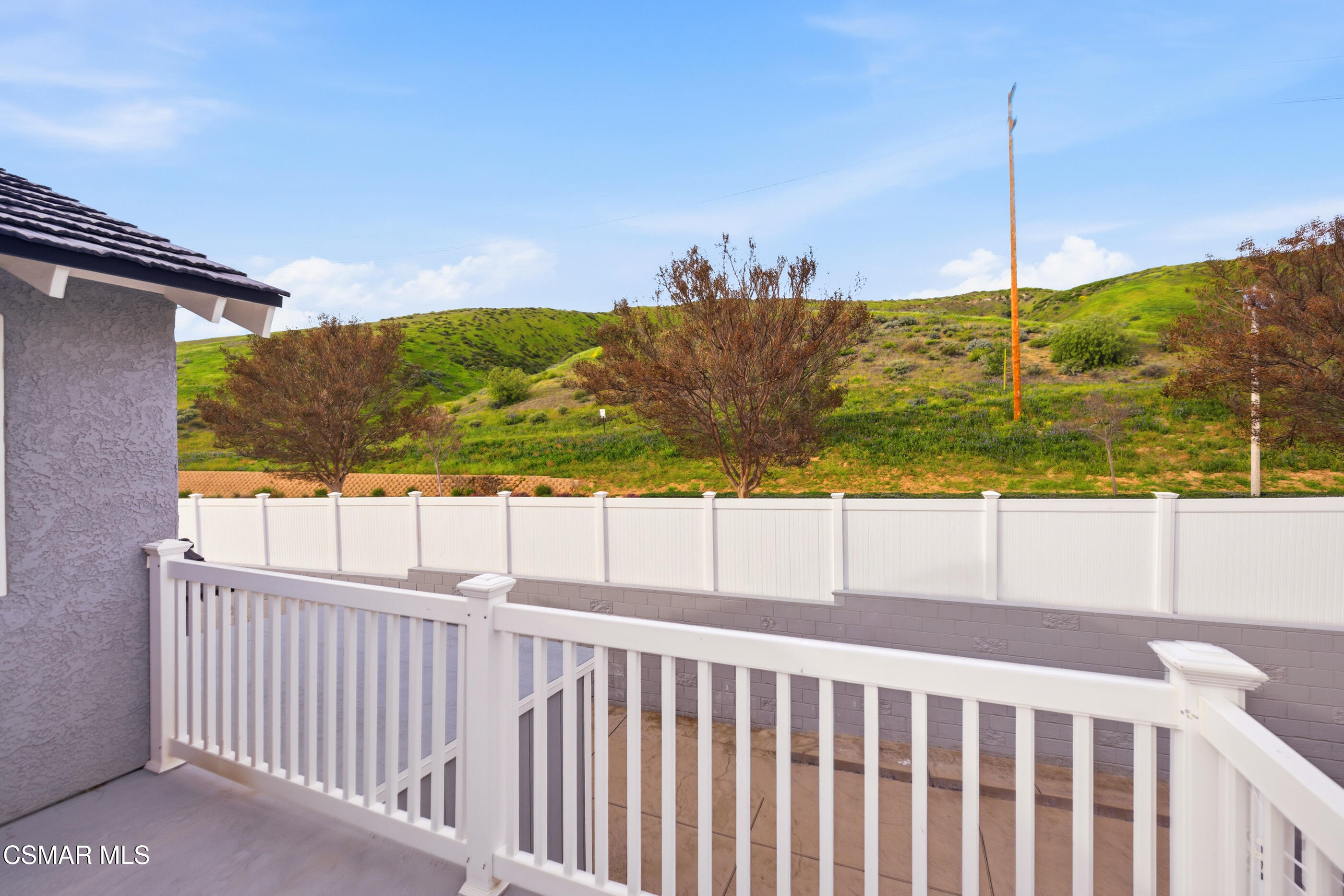 3598 Scofield Avenue Simi Valley, CA 93063 - Photo 49 of 86 a view of a balcony with wooden floor & fence