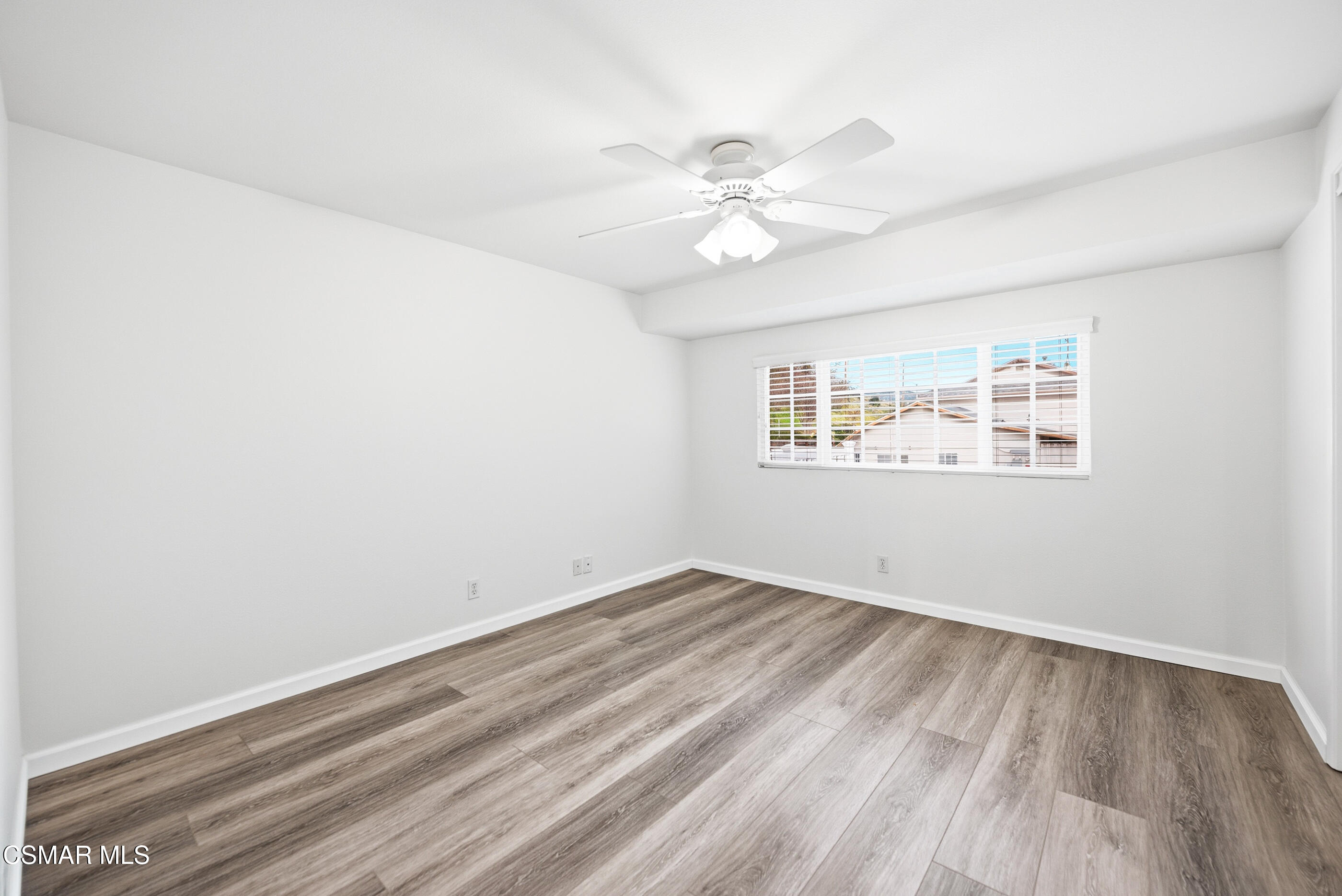 3598 Scofield Avenue Simi Valley, CA 93063 - Photo 57 of 86 an empty room with wooden floor fan and windows