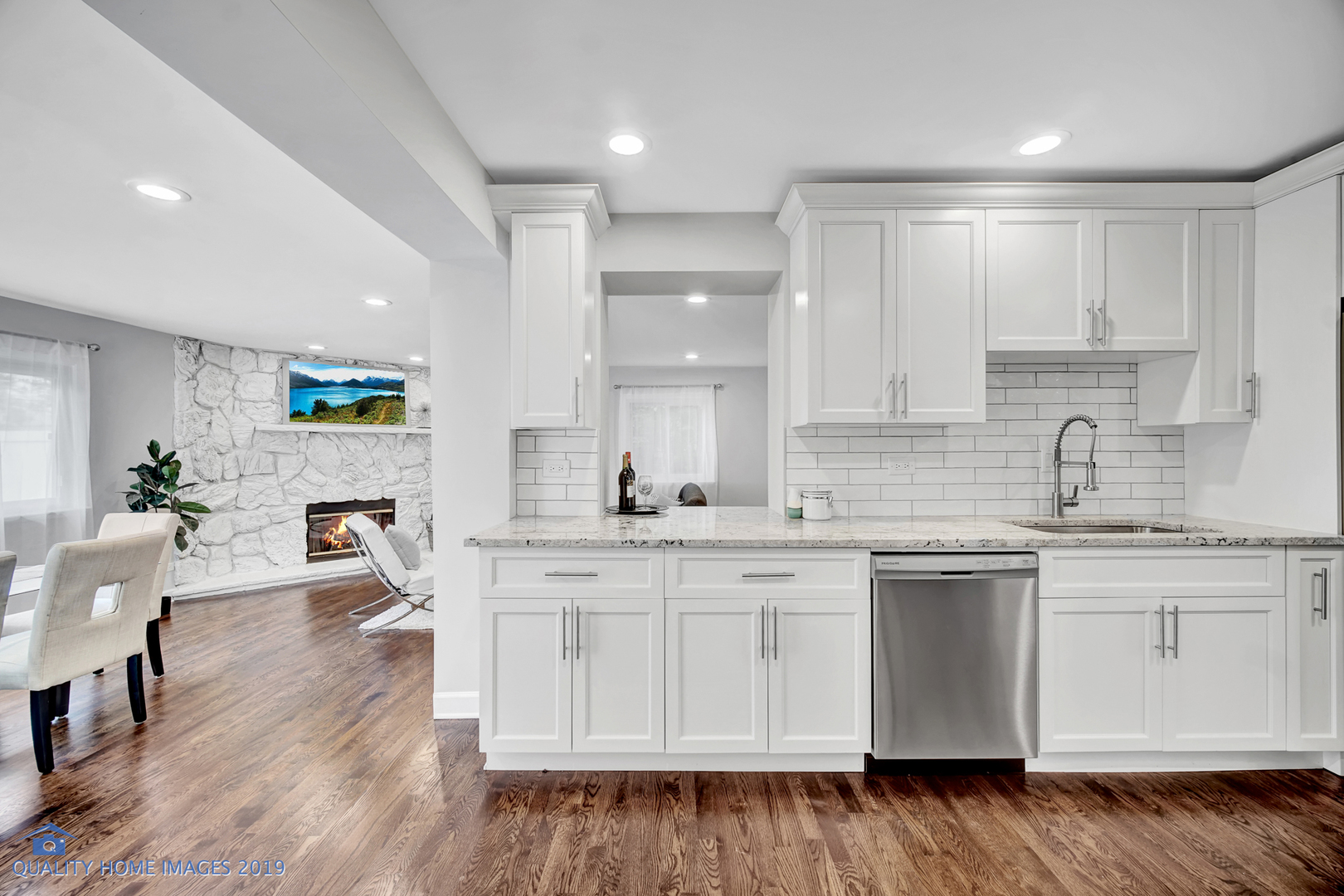 2416 Central Road Glenview, IL 60025 - Photo 8 of 17 a kitchen with a sink white cabinets and wooden floor
