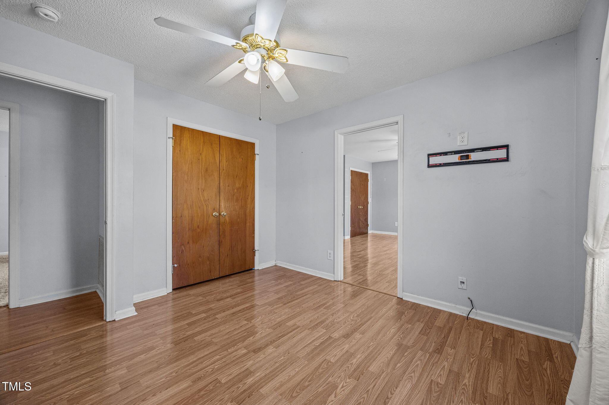 1500 Fairground Road Dunn, NC 28334 - Photo 12 of 31 an empty room with wooden floor and ceiling fan
