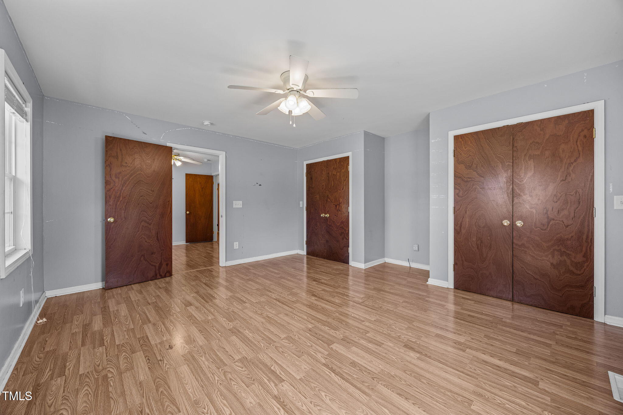 1500 Fairground Road Dunn, NC 28334 - Photo 13 of 31 a view of an empty room with wooden floor and a ceiling fan