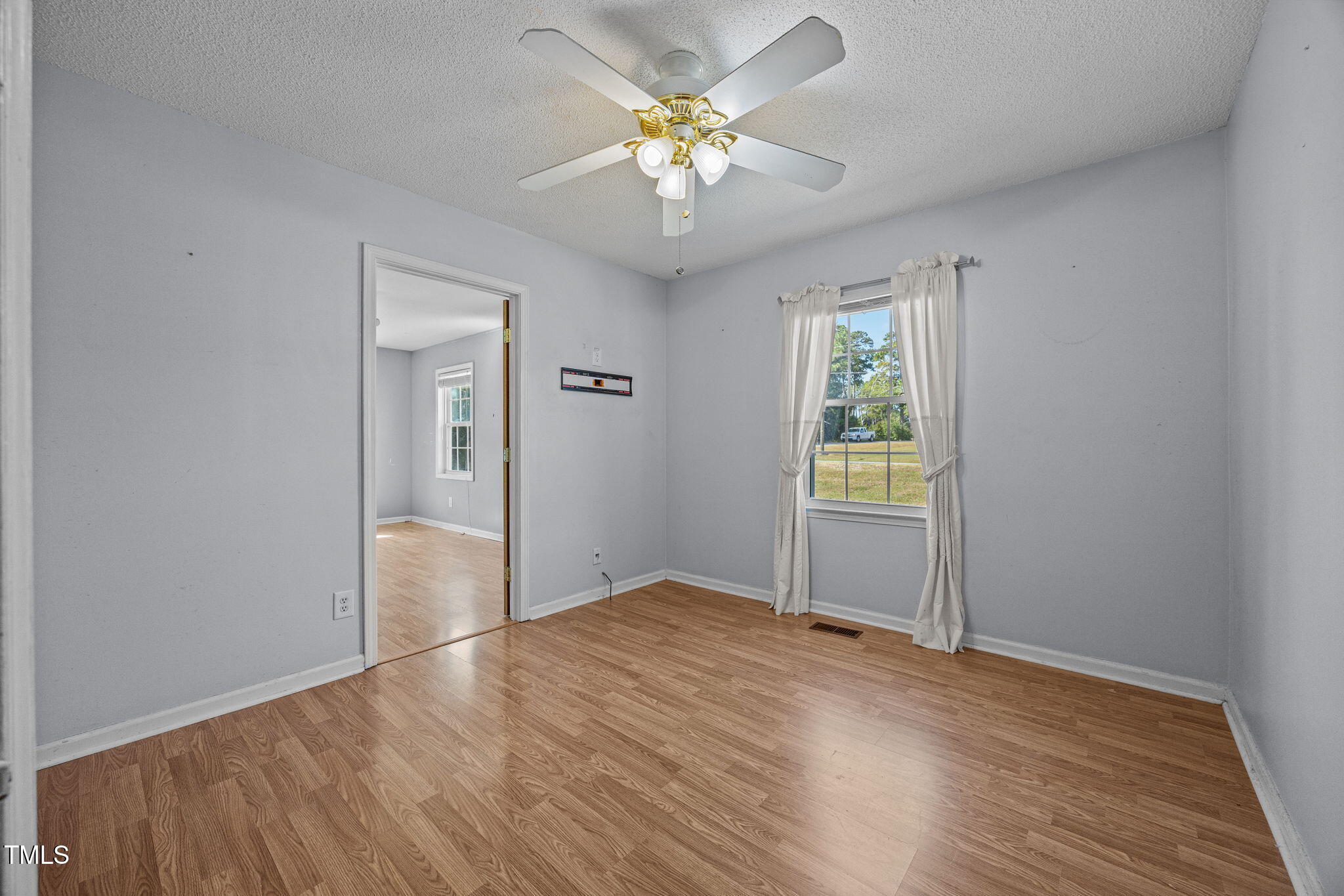 1500 Fairground Road Dunn, NC 28334 - Photo 15 of 31 wooden floor in an empty room with a window
