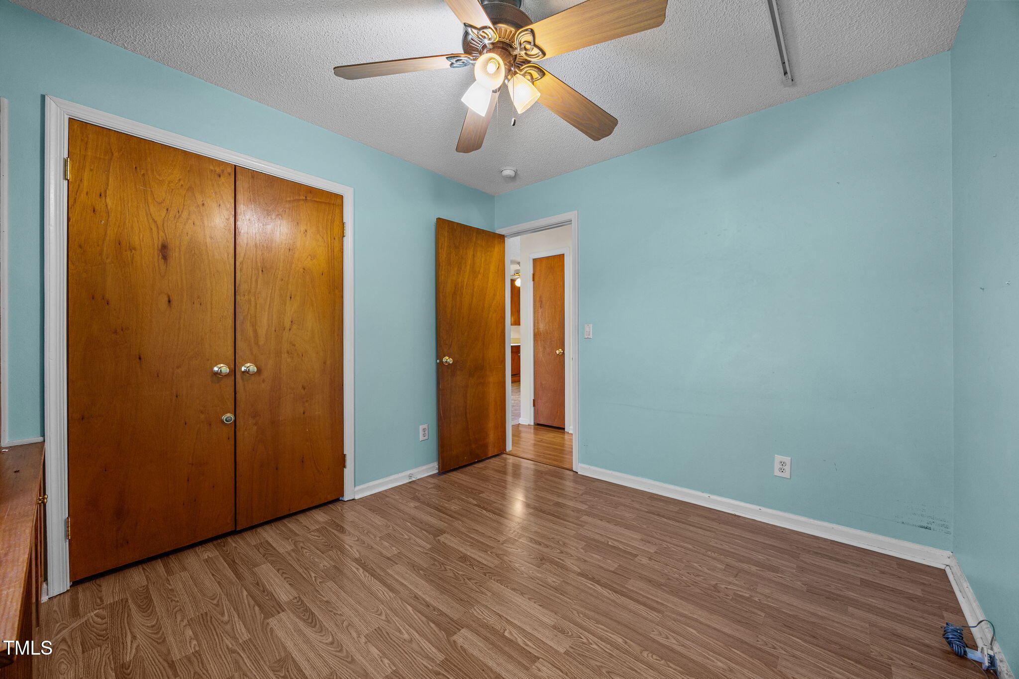1500 Fairground Road Dunn, NC 28334 - Photo 17 of 31 wooden floor in an empty room with a chandelier fan