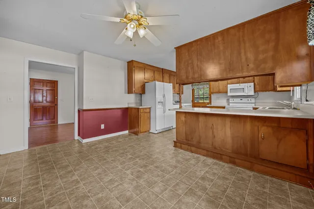 a spacious bathroom with a granite countertop sink a mirror and shower