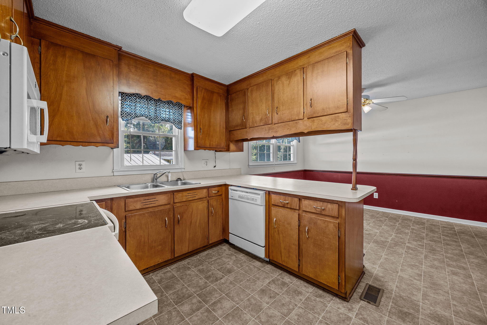 1500 Fairground Road Dunn, NC 28334 - Photo 3 of 31 a kitchen with stainless steel appliances granite countertop a sink stove and cabinets