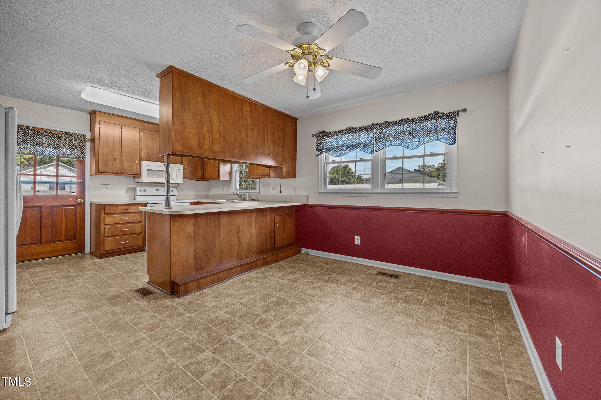 1500 Fairground Road Dunn, NC 28334 - Photo 4 of 31 a kitchen with kitchen island a stove a sink and a chandelier