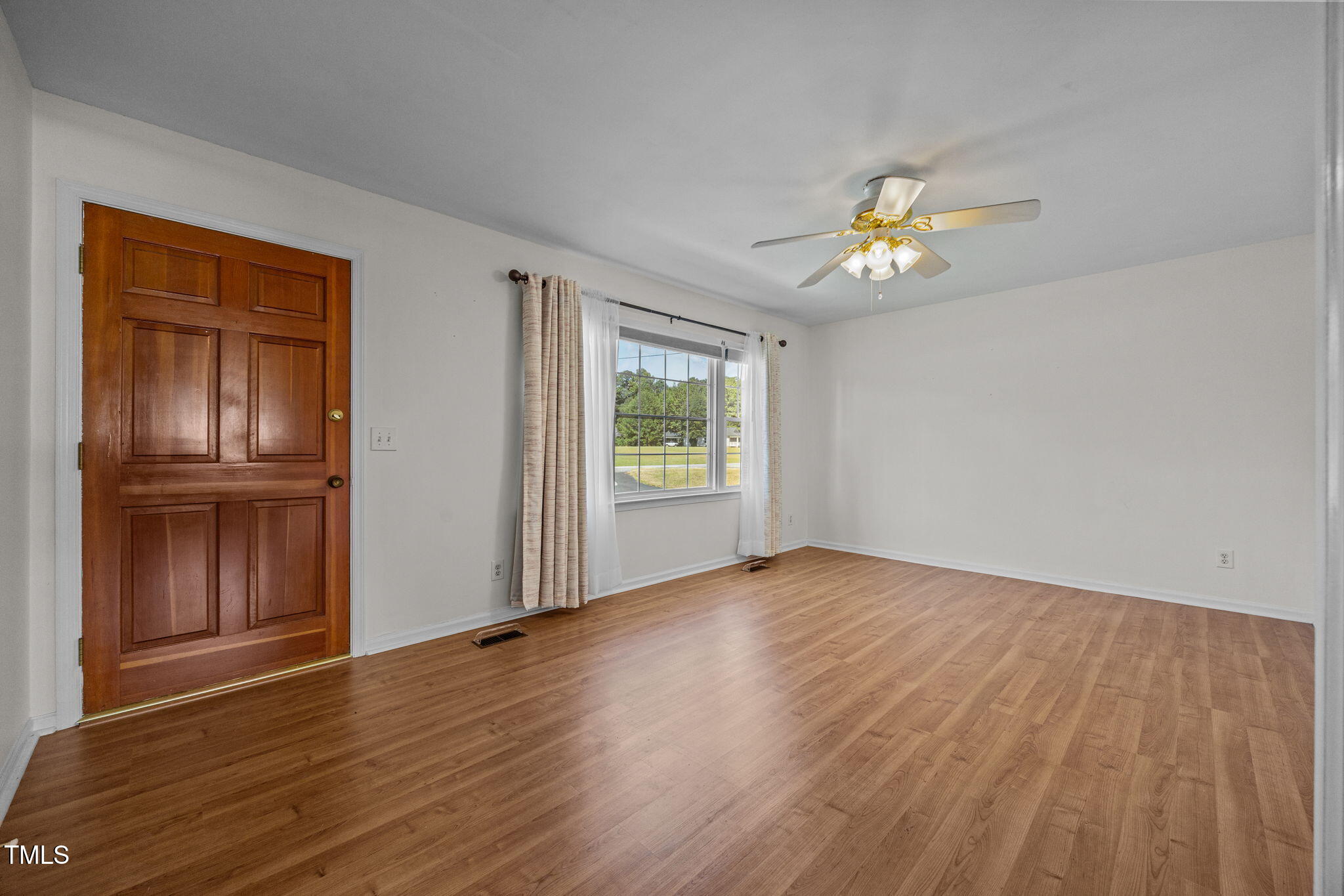 1500 Fairground Road Dunn, NC 28334 - Photo 5 of 31 a view of empty room with wooden floor and fan