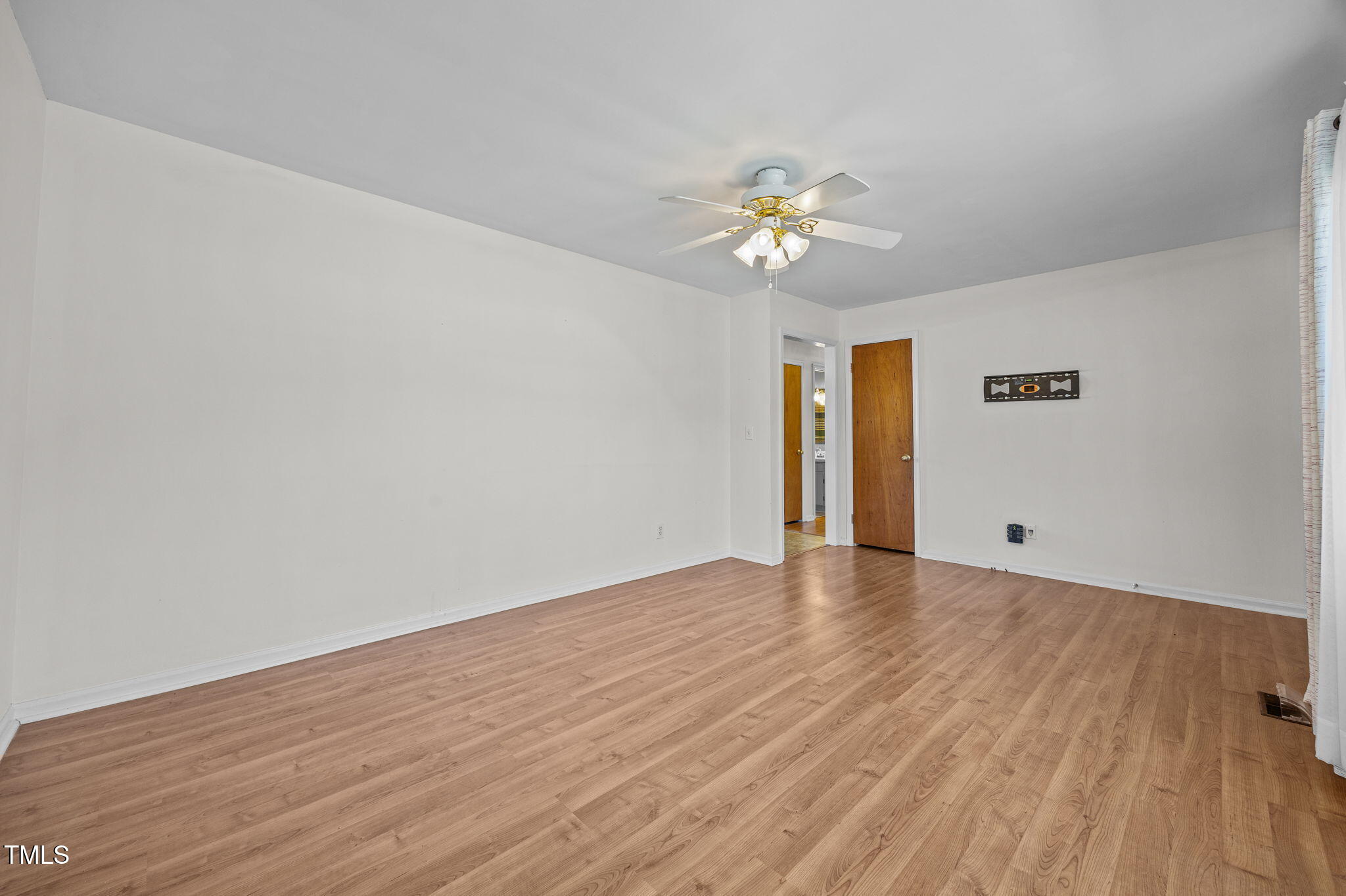 1500 Fairground Road Dunn, NC 28334 - Photo 6 of 31 a view of empty room with wooden floor and ceiling fan