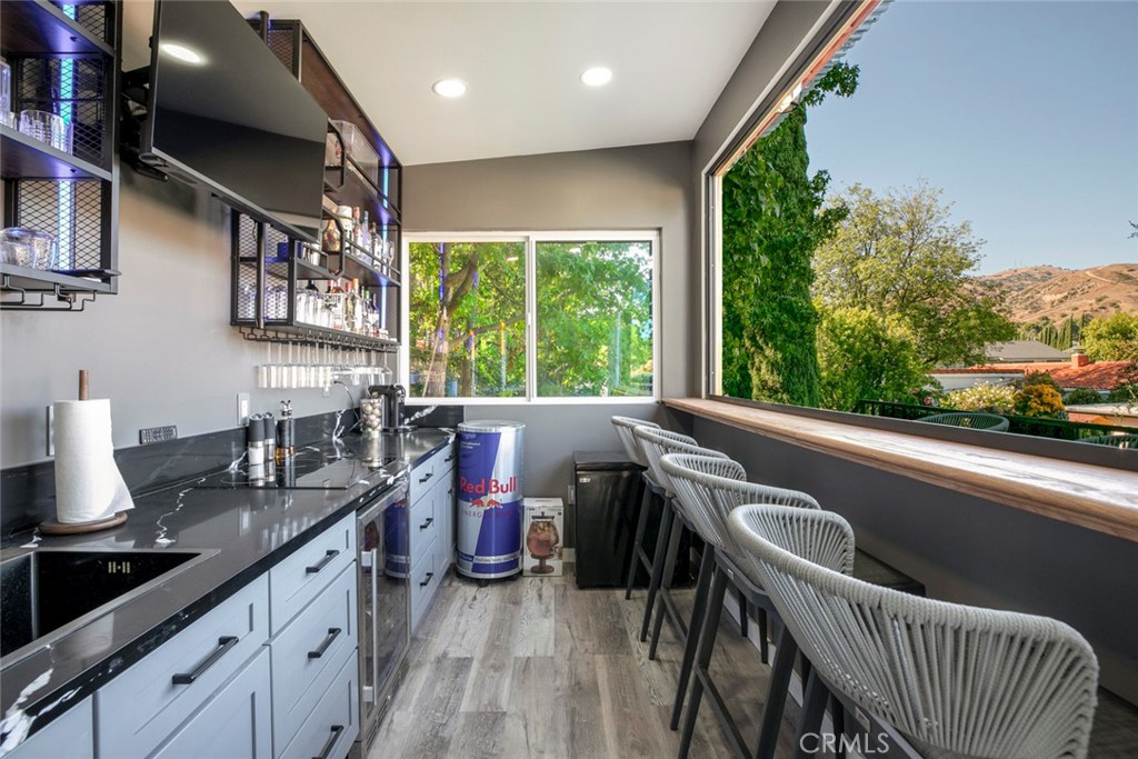 18810 Kirkcolm Lane Porter Ranch, CA 91326 - Photo 47 of 75 a kitchen with a stove a sink and a wooden cabinets