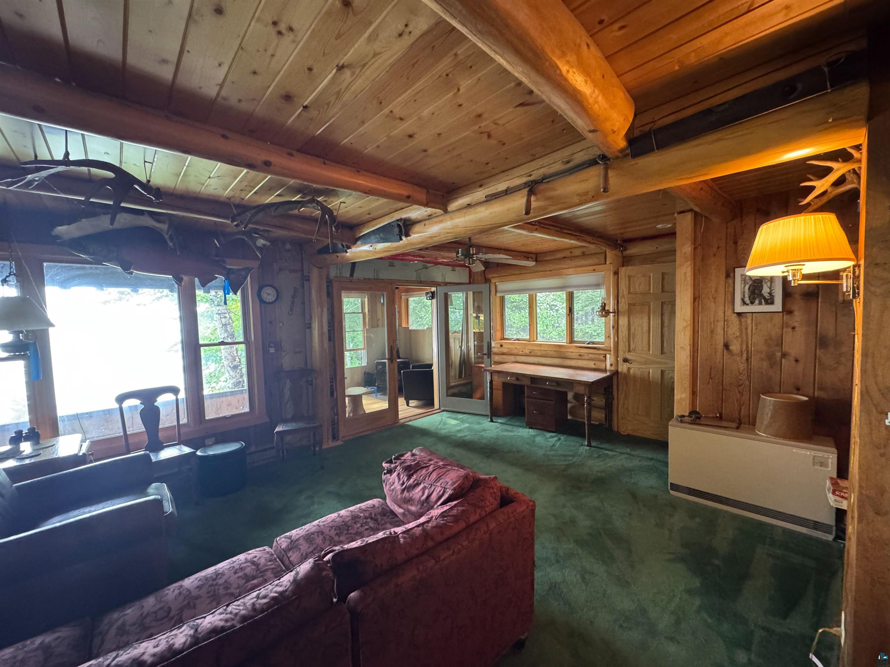 465 South Gunflint Lake Road Grand Marais, MN 55604 - Photo 27 of 46 Wood-paneled interior featuring exposed timber beams and planked ceilings