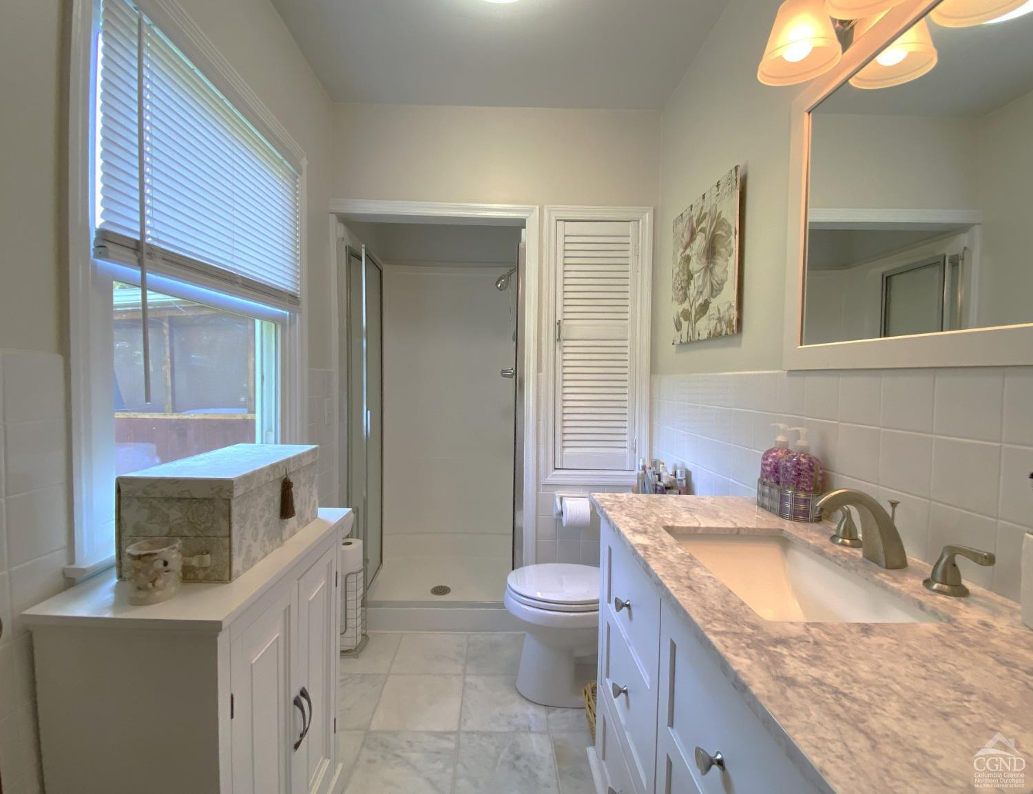 541 Church Road Hudson, NY 12534 - Photo 14 of 21 a bathroom with a granite countertop sink mirror vanity and toilet