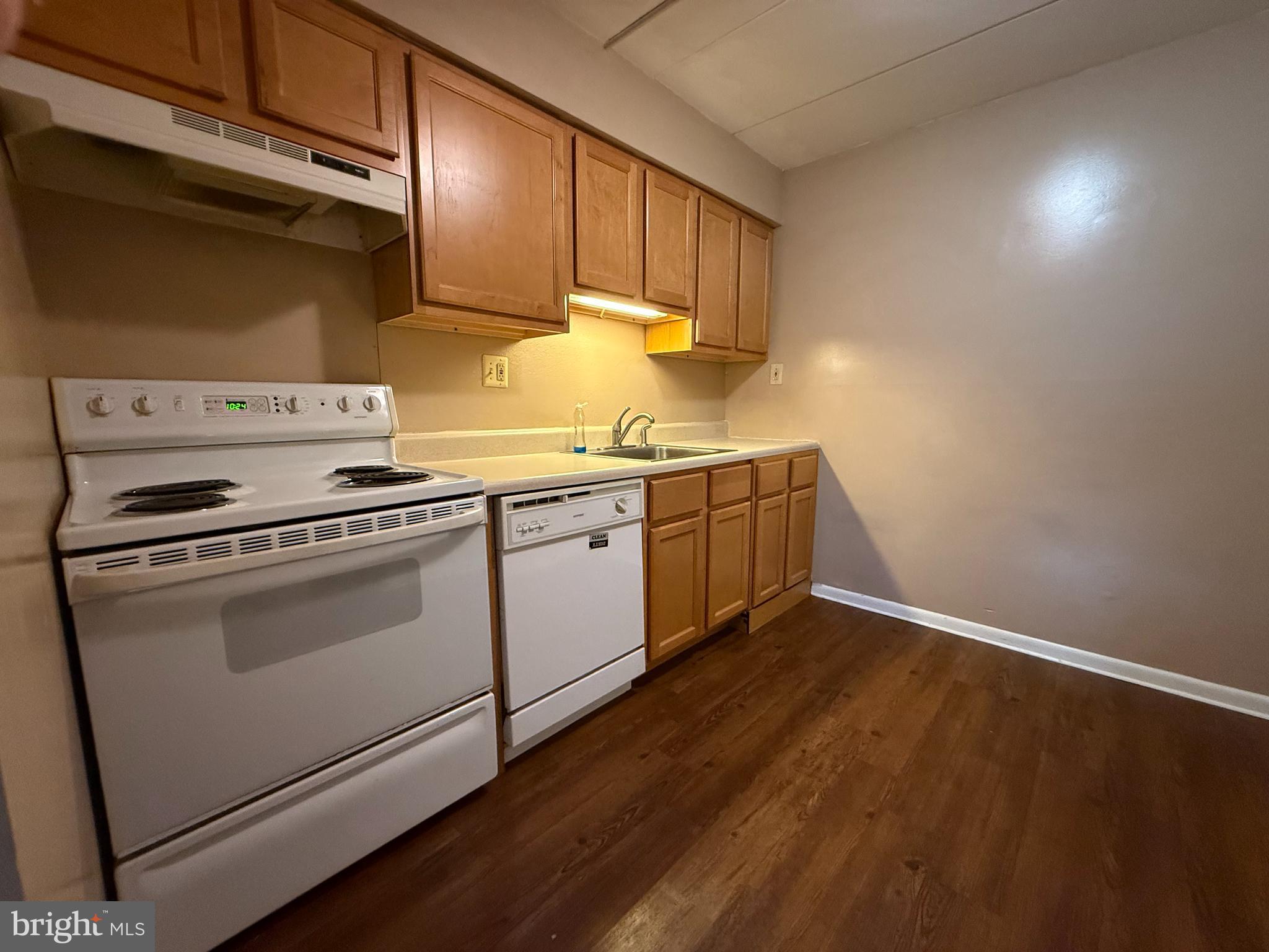 400 Glendale Road, Unit 23 Havertown, PA 19083 - Photo 5 of 12 a kitchen with granite countertop a sink cabinets and stainless steel appliances