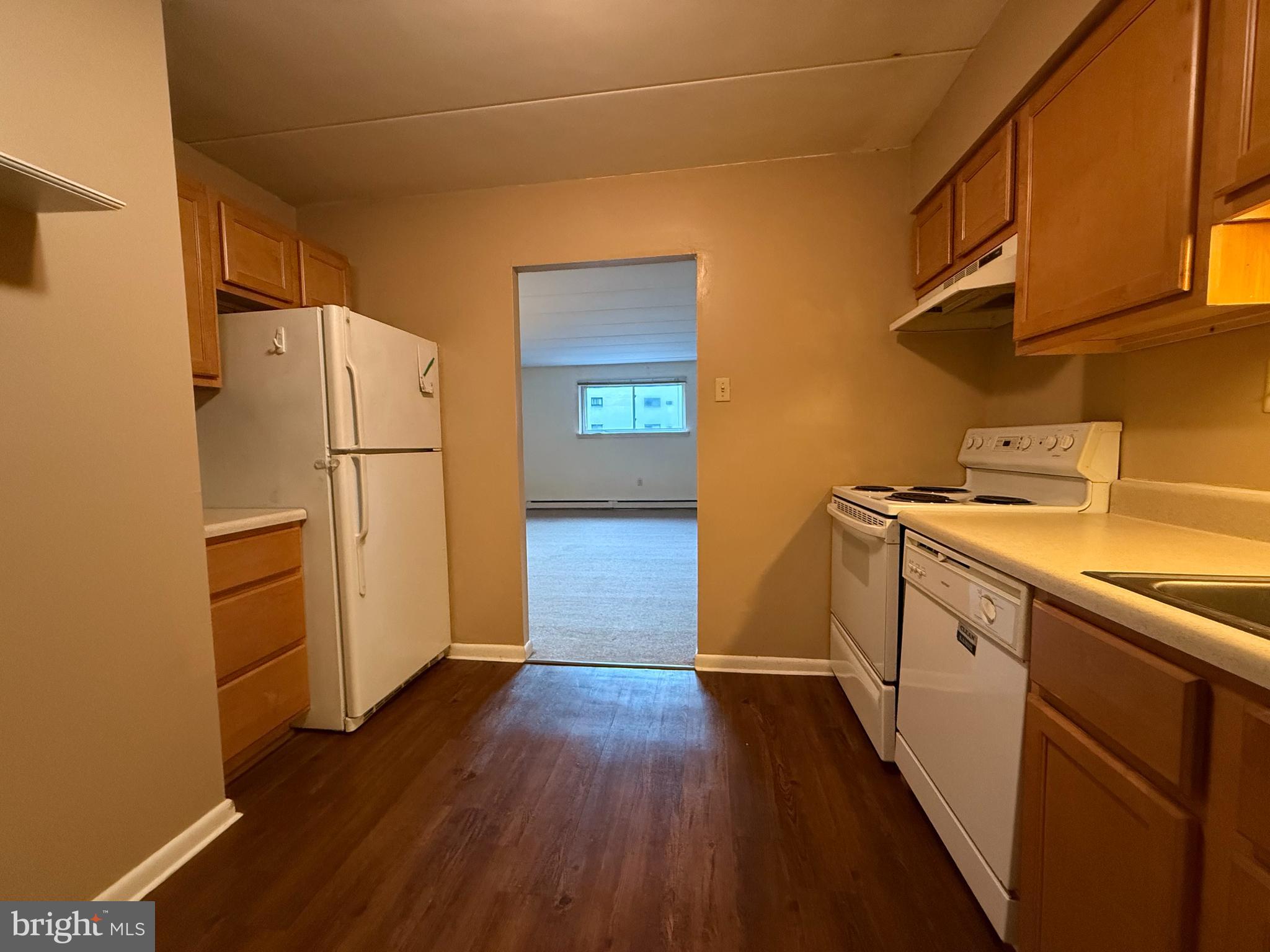 400 Glendale Road, Unit 23 Havertown, PA 19083 - Photo 6 of 12 a kitchen with a refrigerator a sink and wooden floor