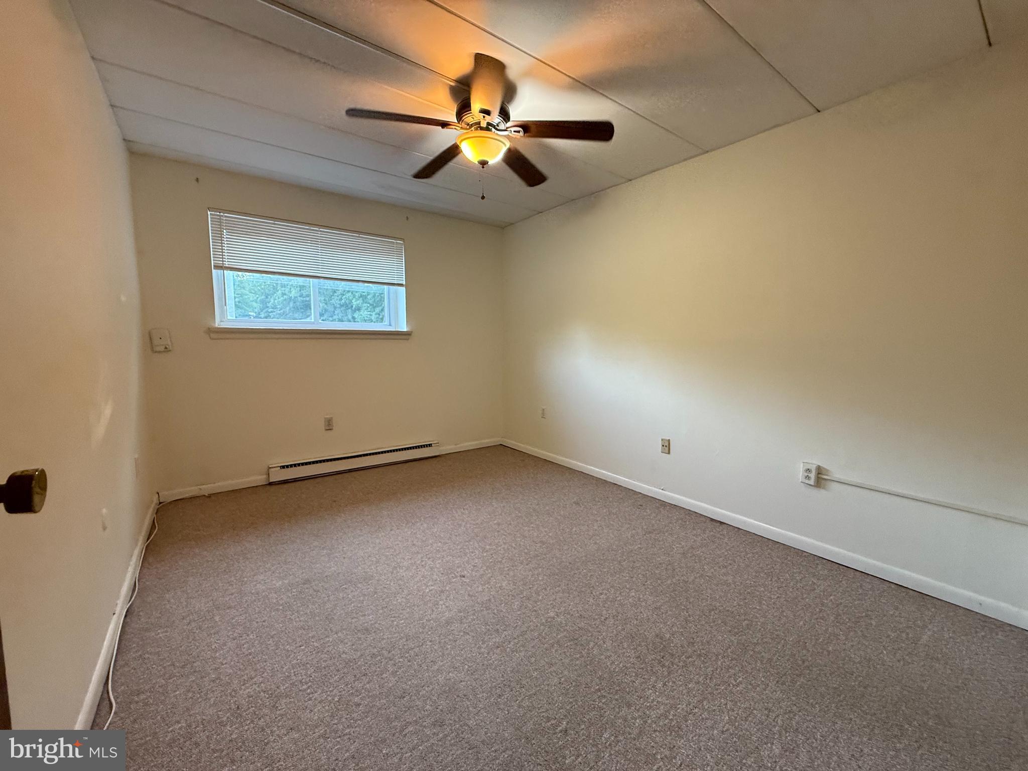 400 Glendale Road, Unit 23 Havertown, PA 19083 - Photo 9 of 12 an empty room with a ceiling fan and window