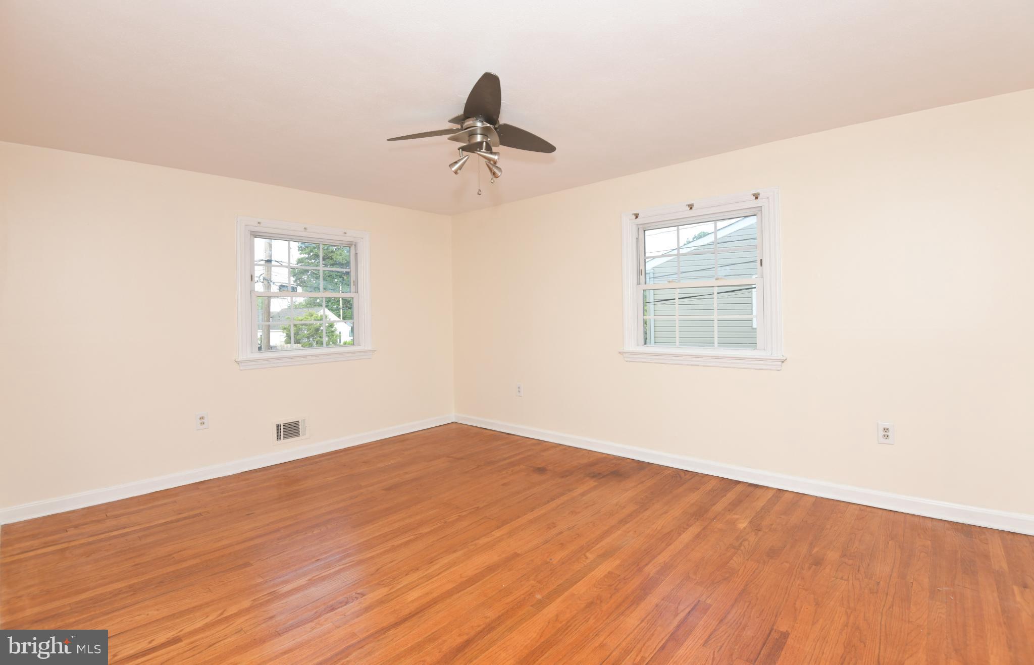 15 Constance Drive Hamilton, NJ 08620 - Photo 16 of 29 an empty room with wooden floor ceiling fan and windows